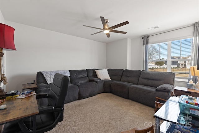 carpeted living area featuring visible vents and ceiling fan