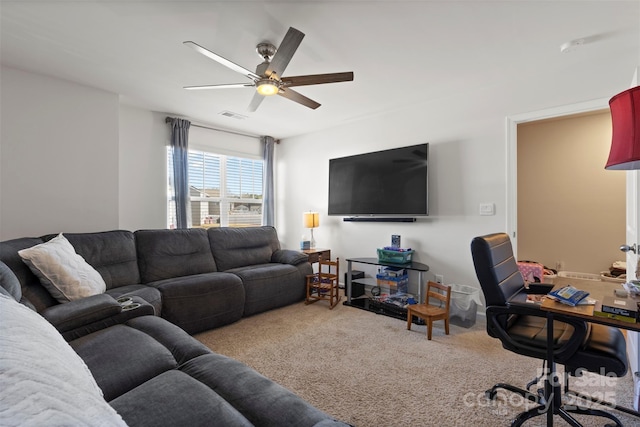 living area with visible vents, carpet floors, and ceiling fan