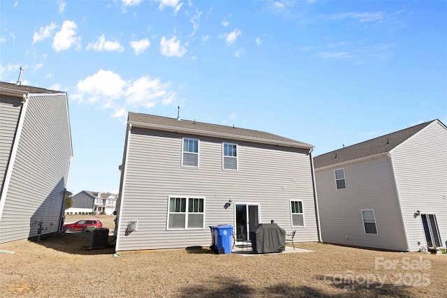 rear view of house with a patio area and central AC unit