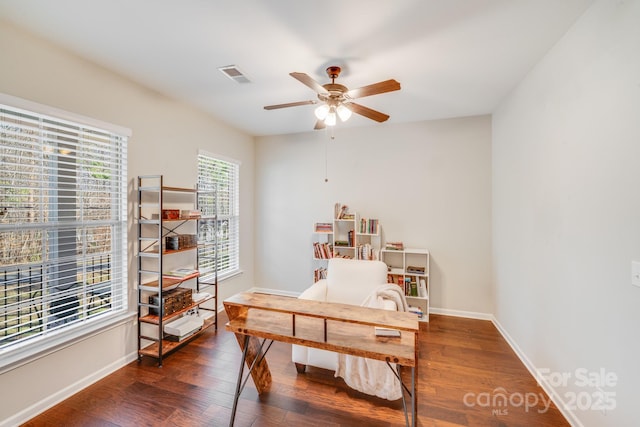 office with visible vents, wood finished floors, baseboards, and ceiling fan