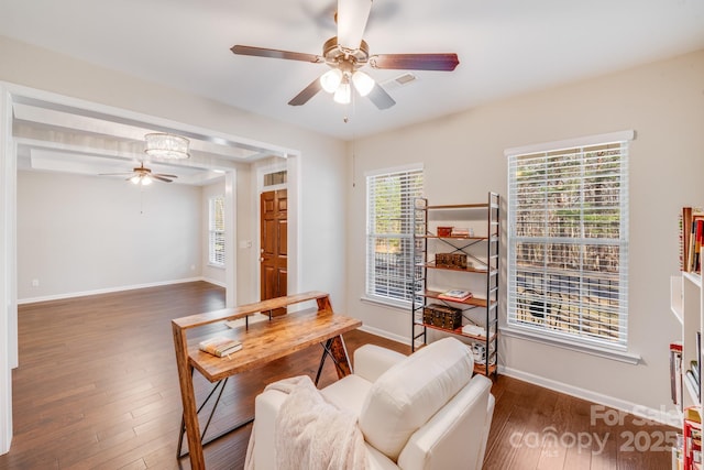 office area featuring visible vents, baseboards, wood finished floors, and a ceiling fan