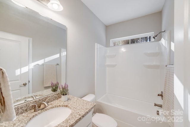 bathroom with toilet, vanity, and shower / bathing tub combination