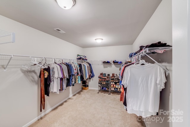 spacious closet featuring visible vents and carpet floors