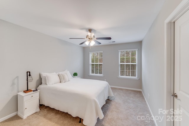 bedroom featuring ceiling fan, light colored carpet, visible vents, and baseboards