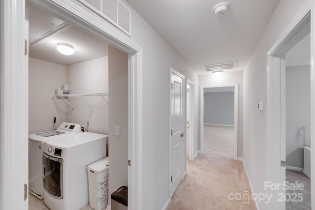 washroom with washer and dryer, laundry area, visible vents, and light carpet