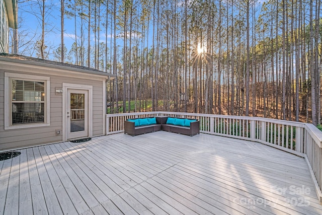 wooden terrace with an outdoor hangout area