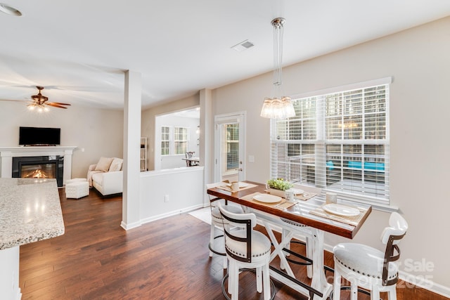 220 Kenway Loop, Mooresville, NC 28117 - dining room featuring a ceiling fan, dark wood finished floors, and a glass covered fireplace