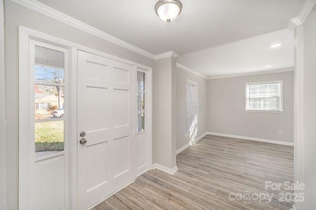 entryway with baseboards, wood finished floors, and crown molding