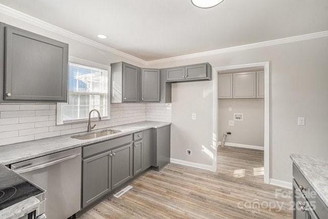 kitchen featuring a sink, gray cabinets, crown molding, light wood-type flooring, and stainless steel dishwasher