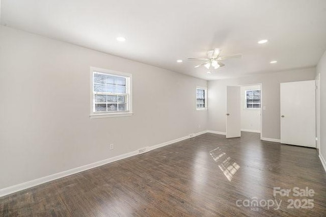 unfurnished room with plenty of natural light, baseboards, dark wood-style flooring, and recessed lighting