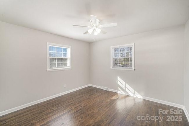 unfurnished room featuring ceiling fan, wood finished floors, and baseboards