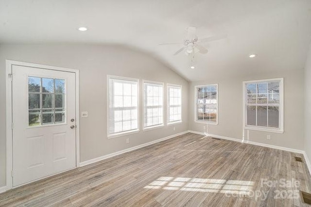 interior space featuring lofted ceiling, recessed lighting, wood finished floors, a ceiling fan, and baseboards