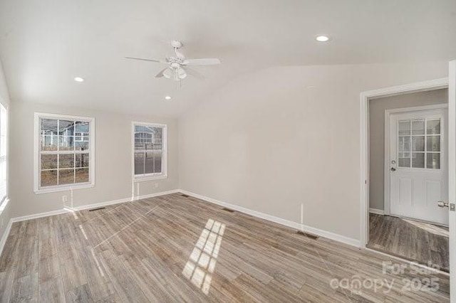 spare room featuring recessed lighting, wood finished floors, a ceiling fan, baseboards, and vaulted ceiling