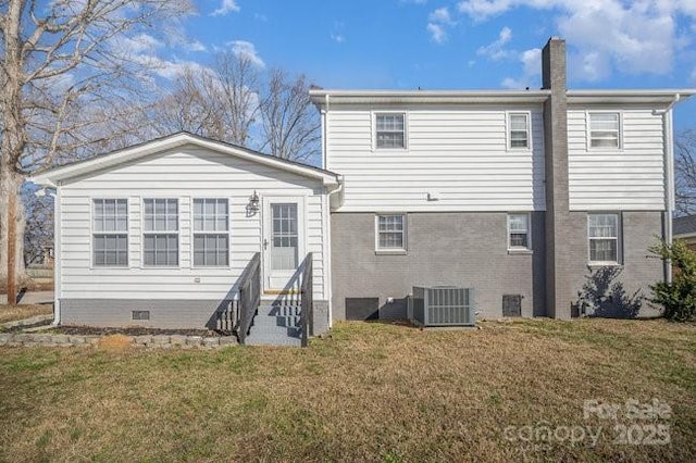 back of house with entry steps, a lawn, a chimney, crawl space, and central AC