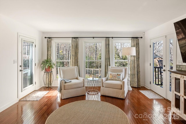 living area with french doors, baseboards, and hardwood / wood-style floors