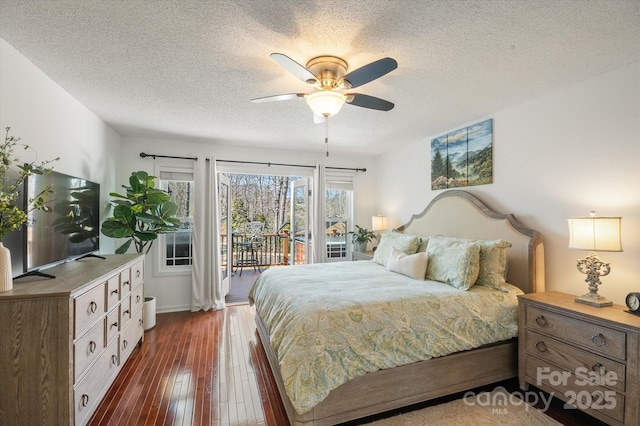 bedroom featuring access to exterior, a textured ceiling, dark wood-type flooring, and a ceiling fan