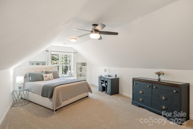 carpeted bedroom featuring vaulted ceiling, baseboards, and ceiling fan