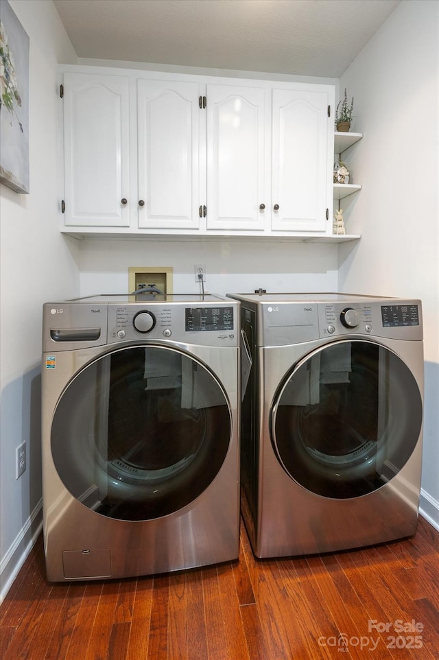 laundry room featuring cabinet space, dark wood-type flooring, baseboards, and separate washer and dryer