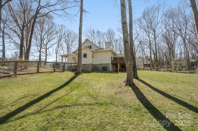 view of yard with a deck and fence