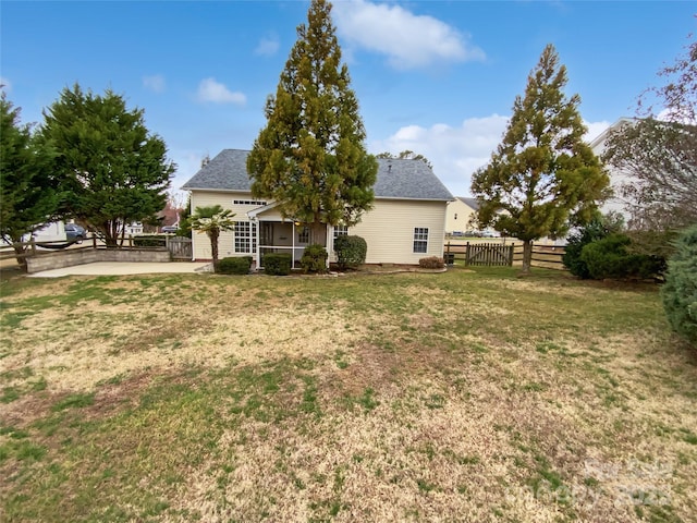 exterior space with fence and a yard