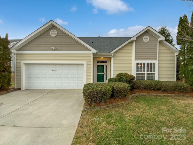 ranch-style house featuring an attached garage, driveway, a front lawn, and roof with shingles