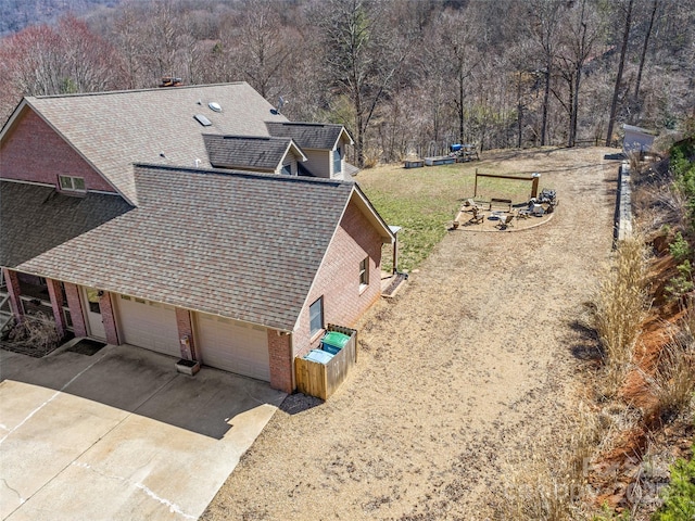 birds eye view of property with a wooded view