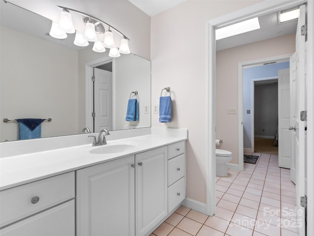 bathroom featuring visible vents, toilet, tile patterned flooring, baseboards, and vanity