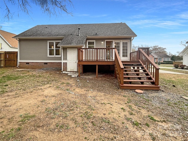 back of property with a deck, fence, roof with shingles, stairway, and crawl space