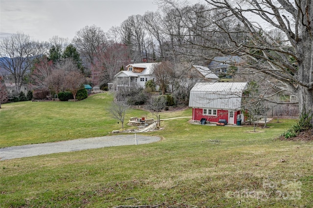 view of yard featuring a barn and an outbuilding