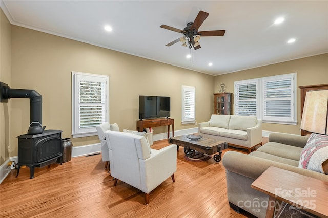 living area with light wood finished floors, baseboards, crown molding, and recessed lighting