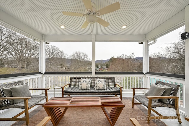 sunroom with a ceiling fan