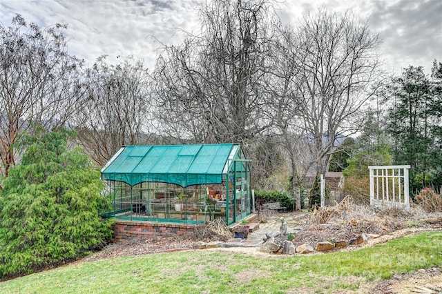 view of yard with an outbuilding and a greenhouse