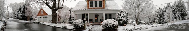 view of front of property with a garage and a water view