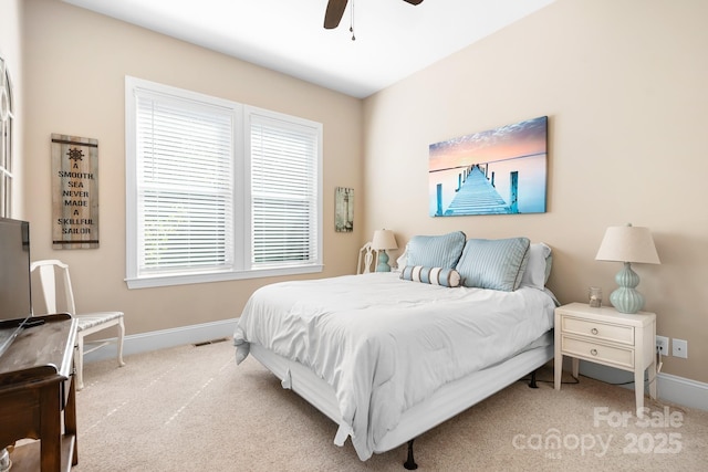 carpeted bedroom featuring visible vents, baseboards, and ceiling fan