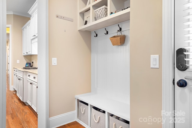 mudroom with baseboards and light wood finished floors