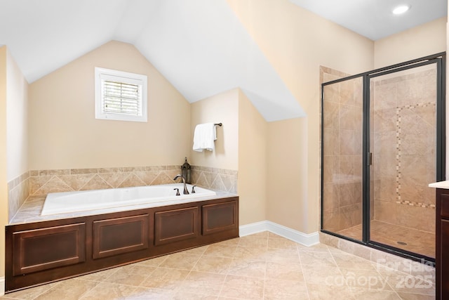 bathroom featuring tile patterned flooring, baseboards, a garden tub, vaulted ceiling, and a stall shower