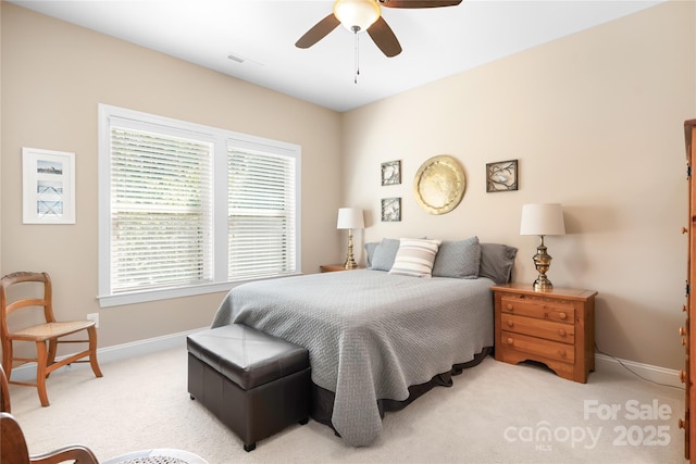 carpeted bedroom with visible vents, ceiling fan, and baseboards