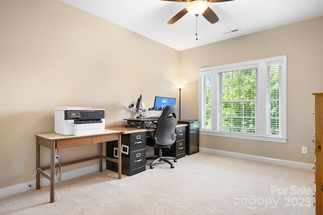 office space featuring ceiling fan, light colored carpet, visible vents, and baseboards