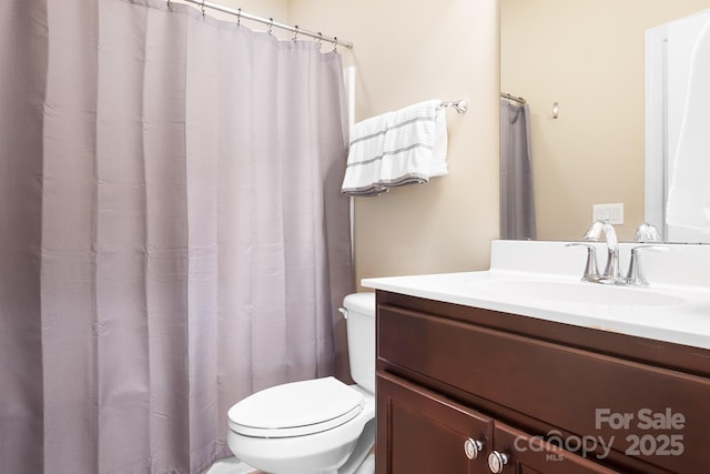 full bathroom featuring vanity and toilet