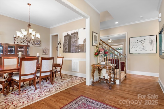 dining area with stairway, wood finished floors, baseboards, and ornamental molding