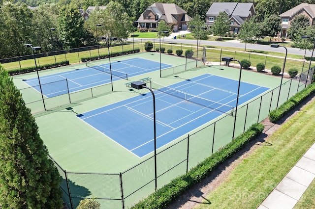 view of tennis court featuring fence