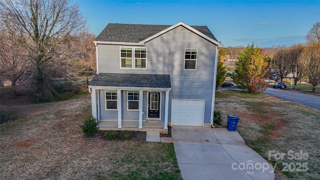 traditional-style home featuring concrete driveway, roof with shingles, and an attached garage