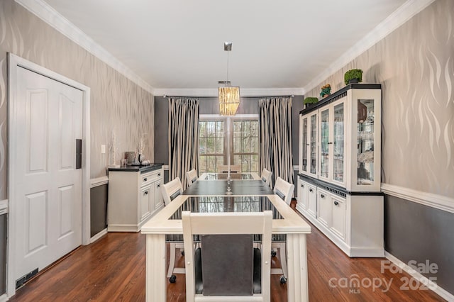dining room featuring dark wood-style flooring and crown molding