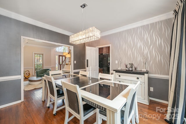 dining area with crown molding, stairway, a notable chandelier, and dark wood finished floors