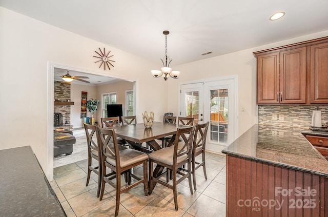 dining room with visible vents, recessed lighting, ceiling fan with notable chandelier, french doors, and light tile patterned floors