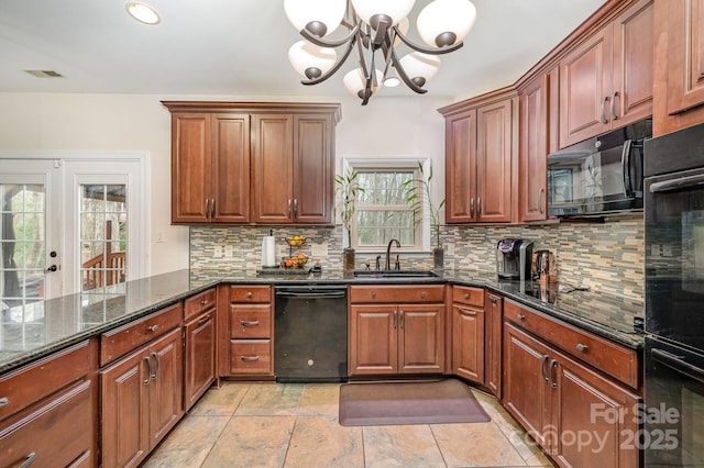 kitchen featuring a sink, dark stone countertops, black appliances, decorative backsplash, and an inviting chandelier