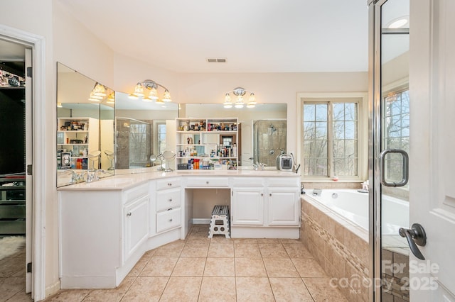 bathroom featuring tile patterned flooring, a shower stall, a garden tub, visible vents, and double vanity