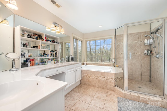 bathroom featuring vanity, a shower stall, tile patterned flooring, a bath, and visible vents