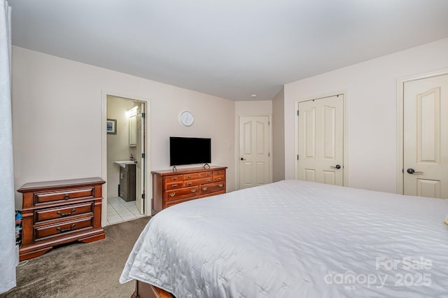 carpeted bedroom featuring ensuite bathroom