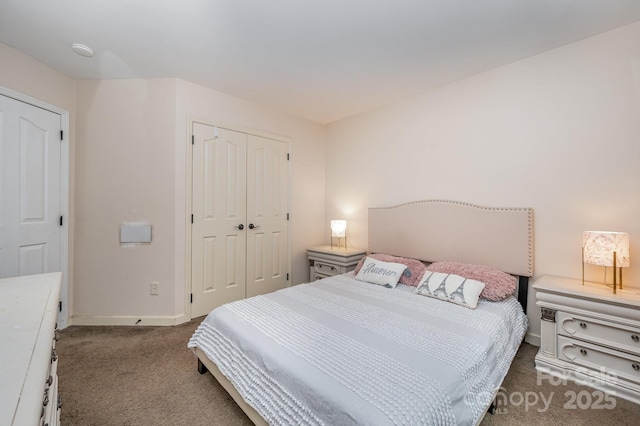 bedroom with a closet, baseboards, and carpet